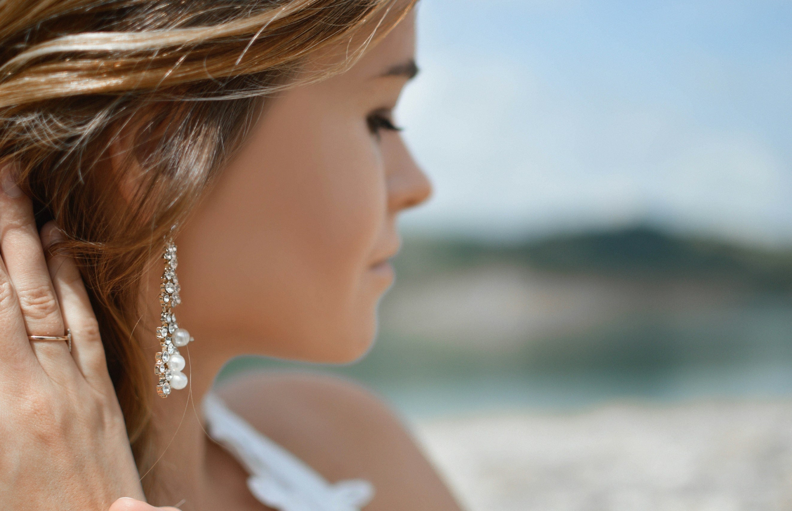 Real Synthetic online jewellery store; woman wearing cubic zirconia pearl earrings